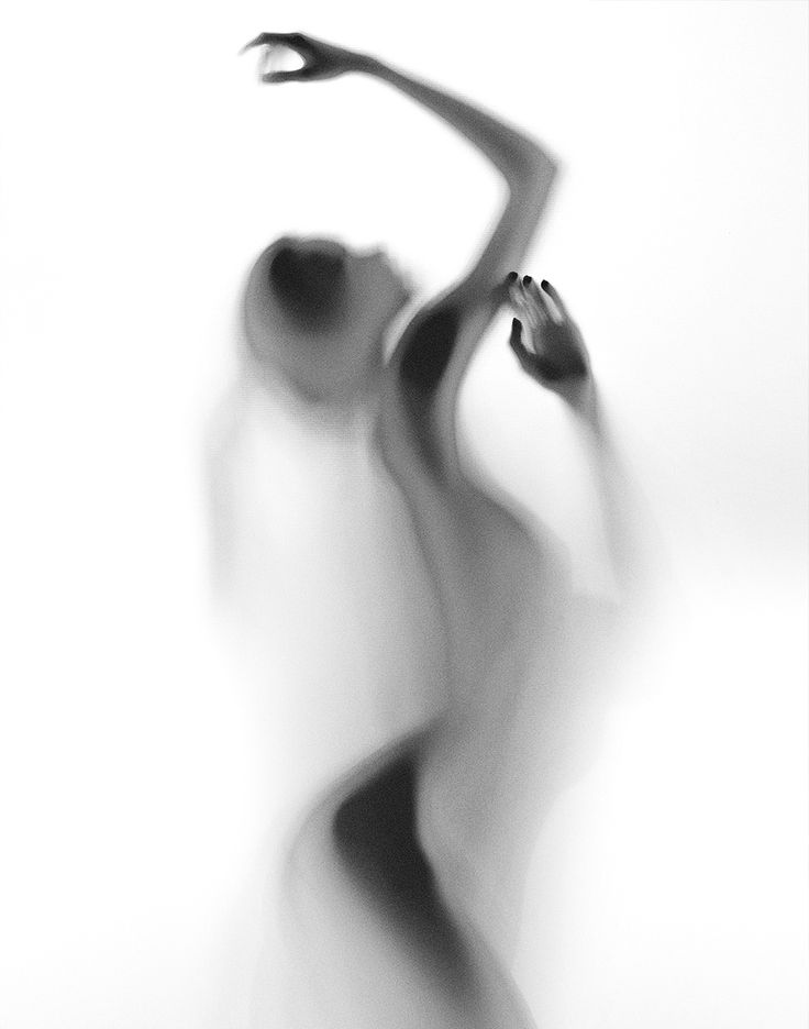 a black and white photo of a woman in motion