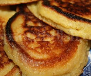 pancakes stacked on top of each other on a blue and white plate