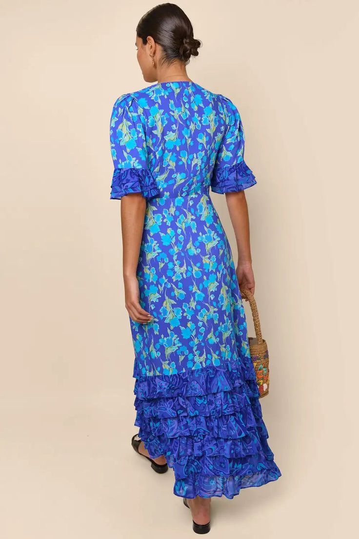 Indulge in the luxurious sophistication of the high-end designer Dress Blue Mari. Handmade with impeccable attention to detail, this long floral dress is perfect for any occasion. From casual shopping trips to elegant banquets, you'll look and feel stunning in the blue floral design. Elevate your wardrobe with this must-have piece. Long Floral Dress, Romantic Blue, Spirit Clothing, Latin Quarter, Above Elbow, Blue Floral Design, Dress With Ruffles, Floral Dresses Long, Floral Print Fabric