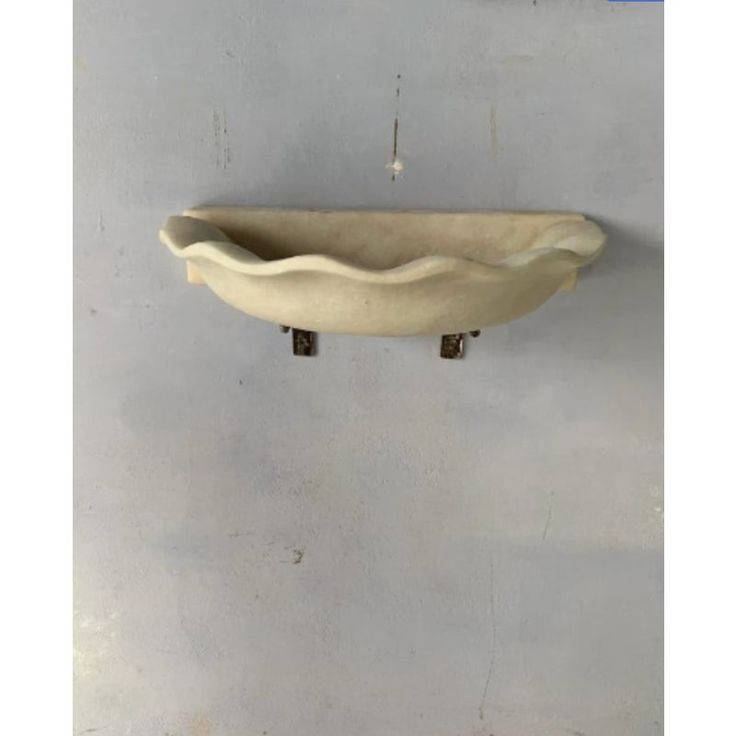 a white bowl hanging on the wall