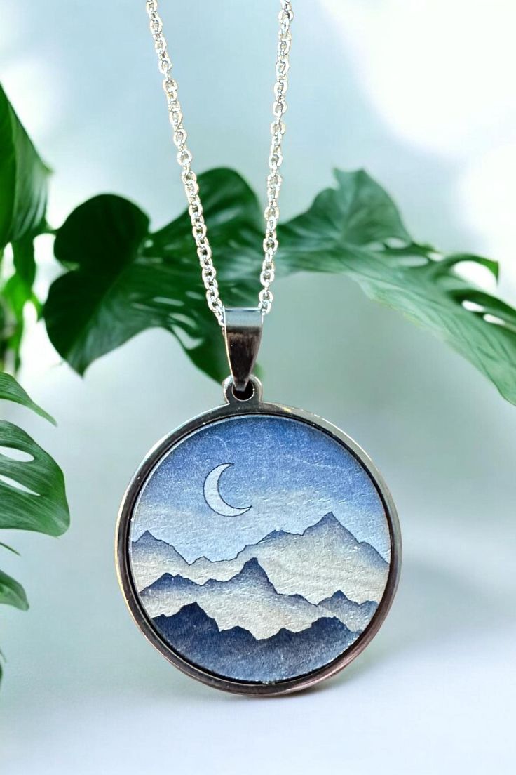 Celebrate your special milestone with our exquisite Mountain Pendant Necklace, a truly unique piece designed to capture the beauty of nature and the essence of your journey together. Perfect for a 5th anniversary gift, this handcrafted wood necklace symbolizes strength, endurance, and the peaks and valleys you've conquered as a couple. Each pendant is meticulously made from high-quality wood, showcasing the intricate details of a mountain landscape, and is paired with your choice of a gold or si Mountain Pendant, Peaks And Valleys, Necklace Moon, 5th Anniversary, Wood Necklace, Wood Pendant, Handcrafted Wood, Anniversary Gift For Her, Moon Necklace