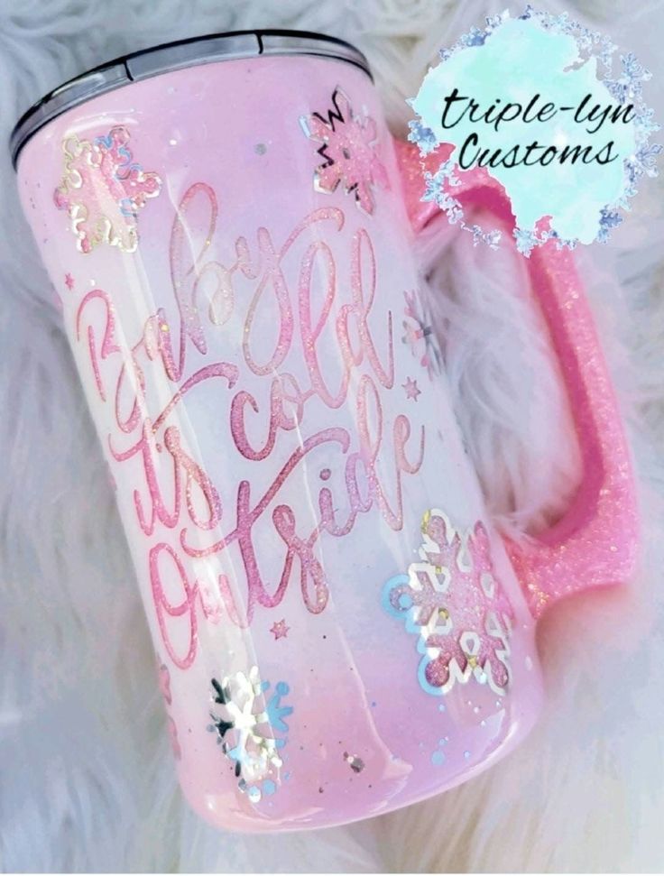 a pink coffee mug with the words be brave on it and snowflakes around it