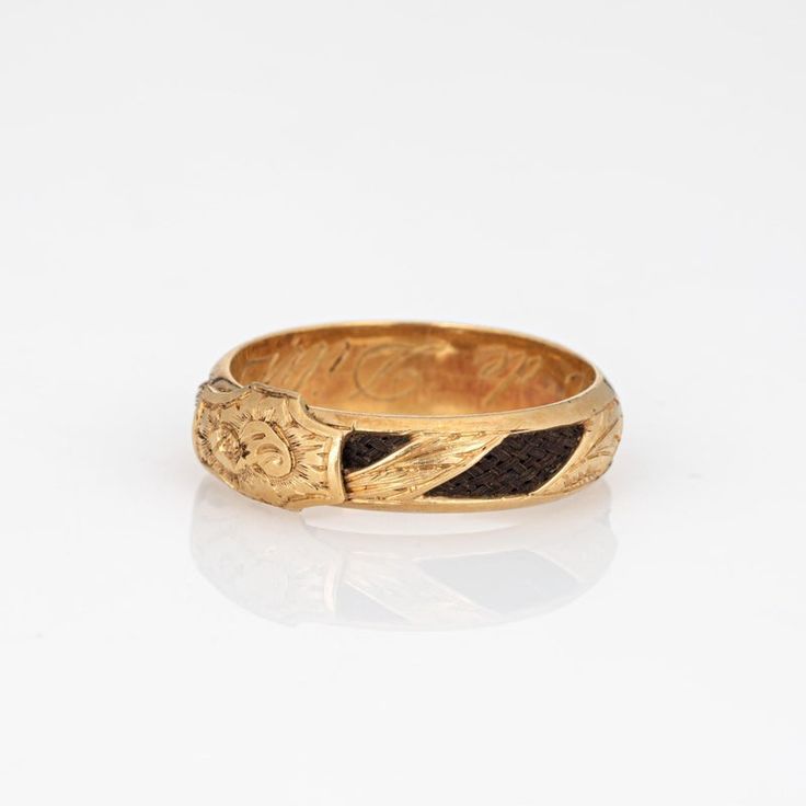 Finely detailed antique Victorian ring (circa 1880s to 1900s), crafted in 18 karat yellow gold.    In the Victorian era, hair jewelry held immense sentimental value and served as a unique and poignant form of remembrance and mourning. The ring has intricately braided hair embedded into the band and around the entire circumference of the ring. Hair jewelry was a deeply personal and intimate memento symbolizing the eternal connection between the living and the departed. Hair jewelry today if sought after by collectors for their tangible links to a bygone era of remembrance and expression. The band has a low profile, rising 3mm from the finger (0.11 inches) and sits comfortably on the finger. The ring is a larger size (US 10) and is unfortunately not sizable. The inner band is engraved 'Amali Victorian Enamel Ring For Anniversary, Antique Engraved Ring With Decorative Band, Formal Carved Yellow Gold Signet Ring, 22k Gold Victorian Ceremonial Jewelry, Victorian Engraved Yellow Gold Ring For Ceremonial Occasion, Victorian Gold Engraved Ring With Decorative Band, Victorian Gold Engraved Ring, Victorian Yellow Gold Enamel Ring For Anniversary, Antique Yellow Gold Enamel Ring