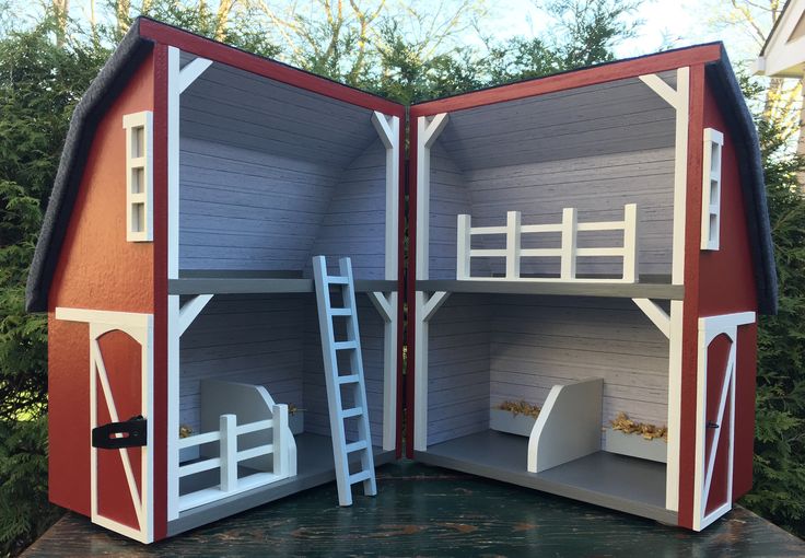 an open dollhouse with two bunk beds and a ladder to the second floor, in front of some trees