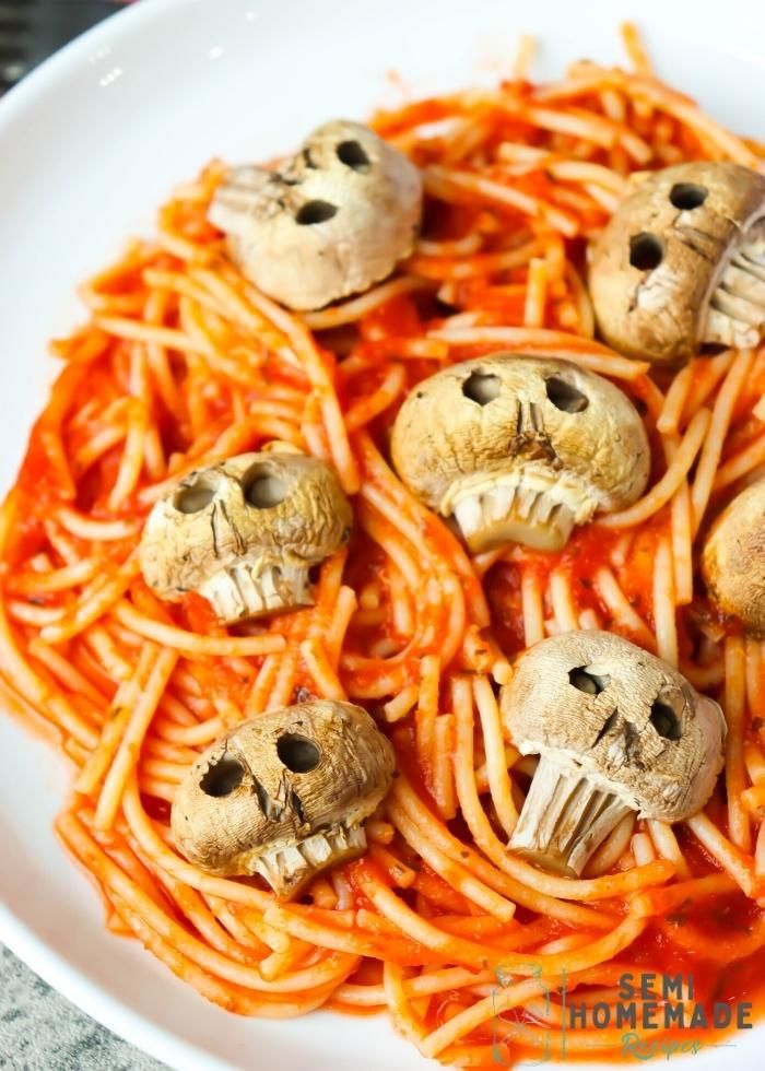 a white plate topped with spaghetti and skulls