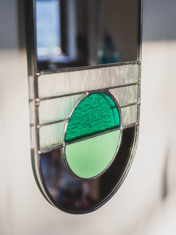 a close up of a green circle on a mirror