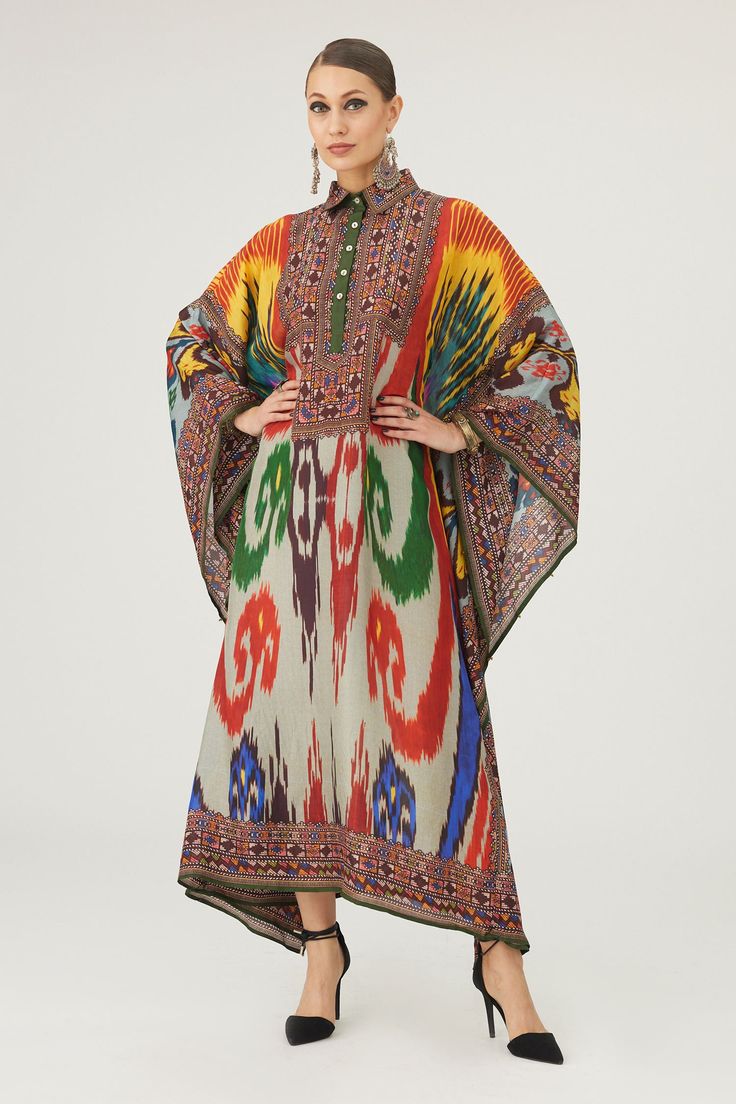 Multi color kaftan crafted in silk base with abstract print.
Components: 1
Pattern: Print
Type Of Work: Abstract
Neckline: Collared Neck
Sleeve Type: Batwing Sleeves
Fabric: Silk
Color: Multi Color
Other Details: 
Geometric print placket and edges
Half button closure
Occasion: Resort - Aza Fashions Elegant Multicolor Kaftan With Kimono Sleeves, Silk Kaftan With Ikat Print For Festive Occasions, Elegant Multicolor Tunic Kaftan, Multicolor Kaftan With Vibrant Print And Kimono Sleeves, Traditional Maxi Kaftan With Ikat Print, Silk Ikat Print Kaftan For Festive Occasions, Designer Silk Kaftan In Maxi Length, Bohemian Designer Wear Kaftan With Traditional Drape, Bohemian Multicolor Maxi Kurta