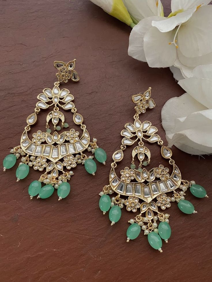 Gorgeous Earrings. Each piece is handcrafted . All the raw material used in this product is of high quality and is handcrafted with love. Height = 125 mm || Width = 65 mm Bollywood Look Indo Western Earring 100% Satisfaction Guarantee: Long Lasting Plating, High-Quality Stones. Gifting: This pair of earrings come in a beautiful gift pack , making it an ideal gift for birthday, wedding anniversary or wedding gift. Occasion: Perfect choice for any Indian occasion. Care: It is advisable that you ke Green Chandbali Chandelier Earrings For Celebration, Traditional Green Dangle Chandbalis, Traditional Green Chandelier Earrings For Celebration, Traditional Green Chandelier Earrings For Festive Occasions, Green Chandelier Earrings For Diwali Gift, Green Meenakari Dangle Danglers, Green Dangle Bridal Earrings For Festivals, Handmade Green Earrings For Diwali, Green Meenakari Chandelier Earrings For Diwali