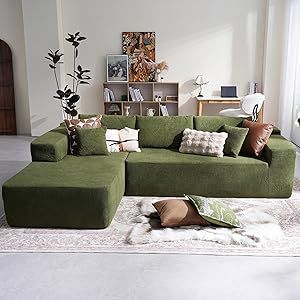 a living room filled with lots of green couches and pillows on top of a rug