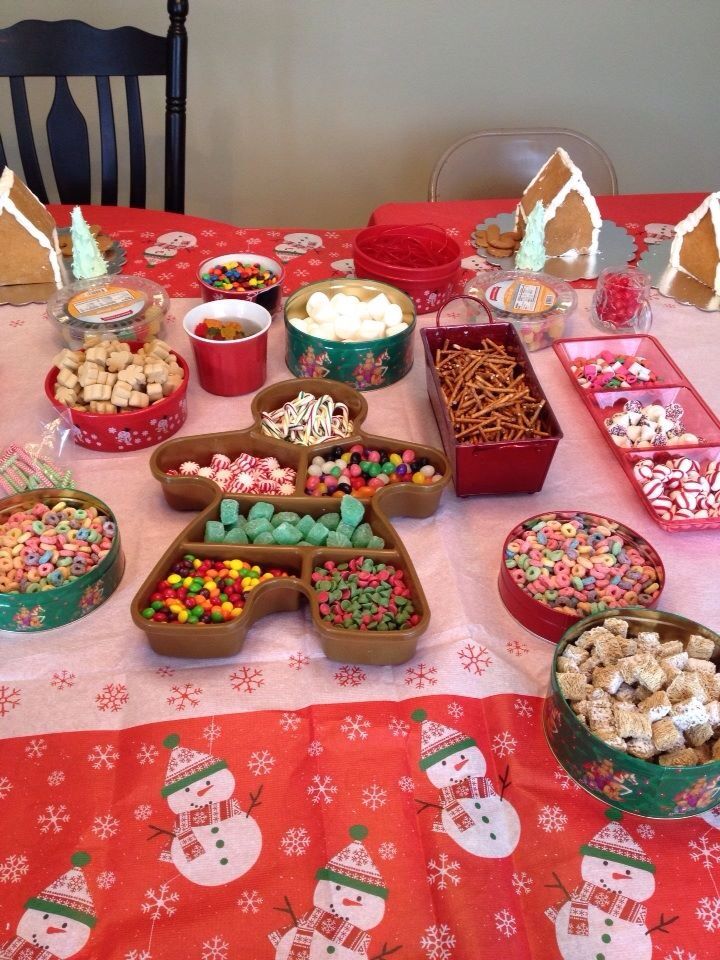 a table topped with lots of food and desserts on top of a red table cloth