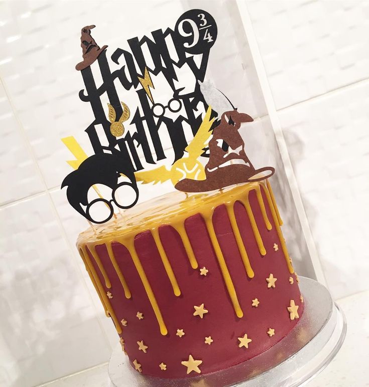 a harry potter themed birthday cake with yellow icing and stars on the bottom layer