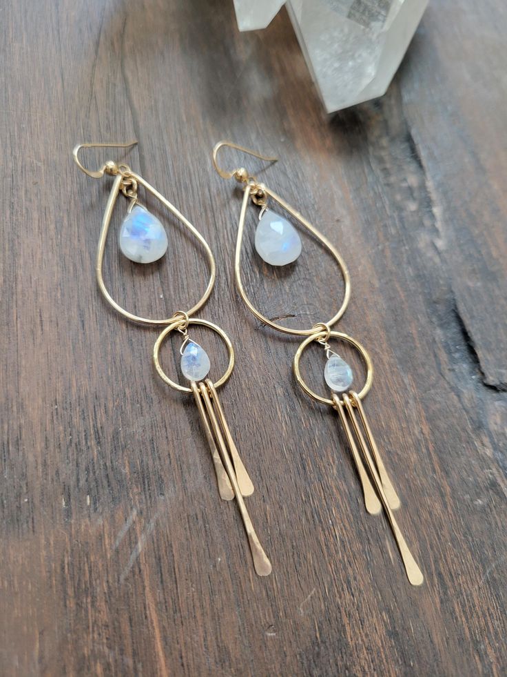 Gorgeous and fun Moonstone Goddess Earrings. Moonstone is said to be a stone of new beginnings. A stone of strength and inner growth. It is also said to be linked to to the divine feminine. It is believed to connect with the moon's energy, bringing balance, calm, abundance, and intuition to the person wearing it. I bet you will also feel your inner goddess when wearing them! Each piece is hammered for texture and shape. The top teardrop hoop and the bottom circle linked to it are not fixed so they will move around creating fun movement. The length is just a little over 3 1/4 in. Each piece is handmade and may vary slightly as well as the stones as they are natural. some will have more blue 'flash" than others. Thank you! Nickel-free Teardrop Spiritual Jewelry, Spiritual Teardrop Nickel-free Jewelry, Celestial Dangle Earrings For Everyday, Celestial Teardrop Earrings Gift, Celestial Teardrop Earrings For Gift, Celestial Style Dangle Earrings For Everyday, Everyday Celestial Dangle Earrings, Celestial Drop Earrings For Everyday, Minimalist Nickel Free Moonstone Earrings