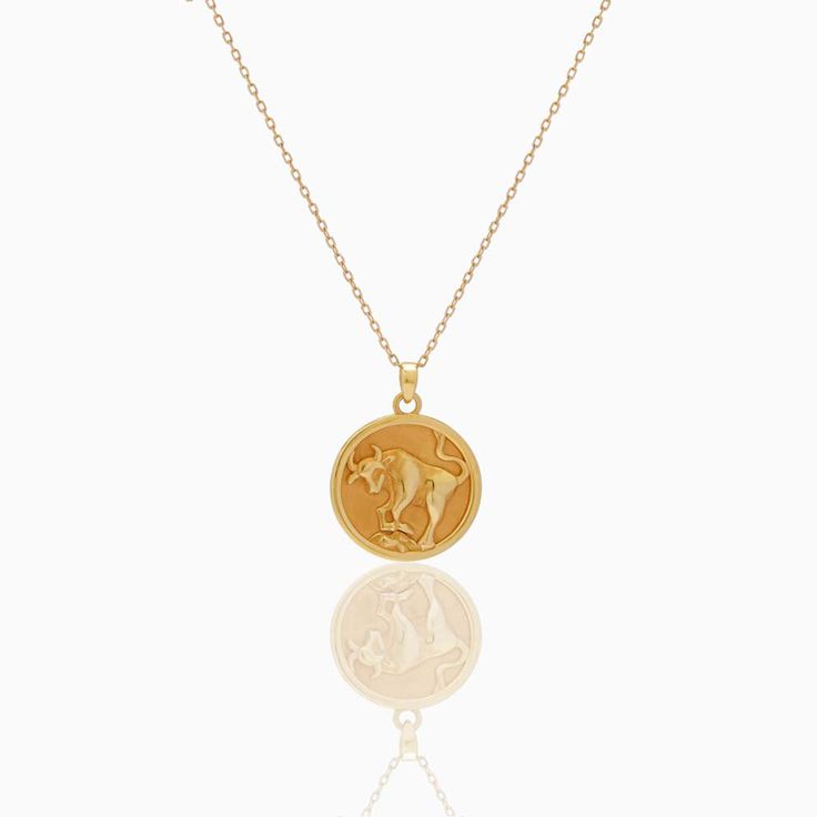 Taurus Zodiac Coin Pendant - Classic. Crafted for you to flaunt your star sign, this necklace goes with every outfit and will give a hint of sentiment wrapped in luxury to your style. The Diamond Bezel around the Gold Coin blends into a delicate yet beautifully detailed piece. Coins 5. 4 grams of 18k yellow gold and 0. 44 ct natural diamonds Yellow Gold Zodiac Sign Medallion Necklace, Luxury Sterling Silver Zodiac Sign Necklaces, 14k Gold Zodiac Medallion Necklace, 14k Gold Zodiac Sign Pendant Necklace, Yellow Gold Zodiac Pendant Necklace, Luxury Zodiac Sign Necklaces, Yellow Gold Zodiac Sign Amulet Necklace, Yellow Gold Zodiac Amulet Necklace, Zodiac Sign Necklace Fine Jewelry Gift