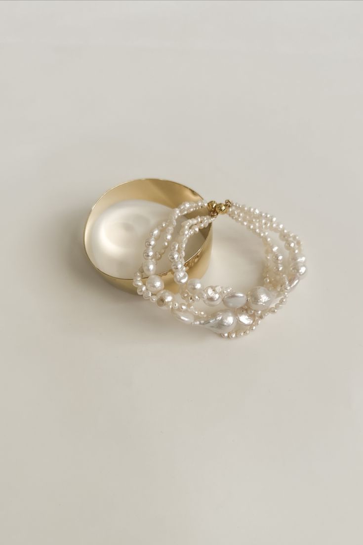 A myriad of pearls, including freshwater + Swarovski, intertwine + wave to create this wildly elegant bracelet— finished with a gold magnetic clasp. #personalstylist #whattowear #grwm #stylingadvice #wedding #bridal #modernaesthetic #style #womensfashion #womenstyle Elegant Baroque Pearl Beaded Bracelets For Wedding, Elegant Baroque Pearl Beaded Bracelets In Pearl White, Multi-strand Pearl Bracelets As Gift, Elegant Multi-strand Adjustable Pearl Bracelet, Multi-strand Pearl Bracelet As Gift, Elegant Multi-strand Beaded Bracelets For Gifts, Elegant Adjustable Multi-strand Pearl Bracelet, Elegant White Multi-strand Bracelets, Beach Inspired Decor