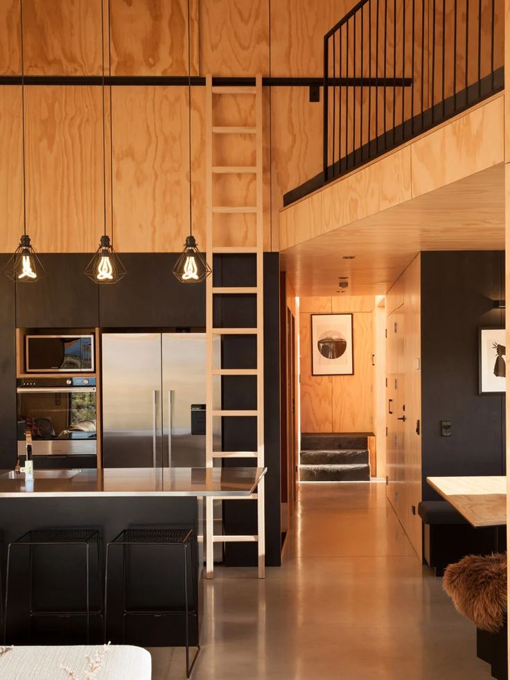 the interior of a modern house with wood paneling