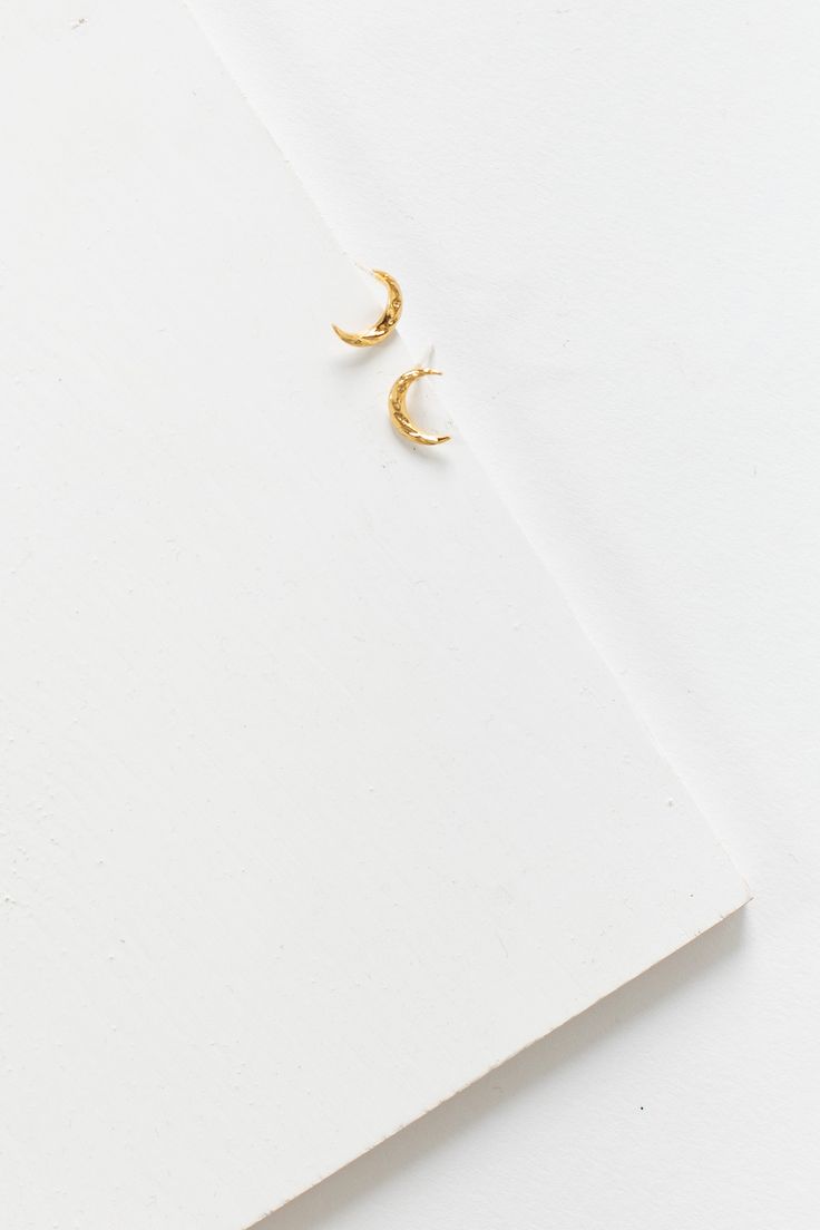 Textured crescent moon earring Post earring Gold plated Approximate measurement - 3/8" Minimalist Moon-shaped Pierced Hoop Earrings, Gold Crescent Earrings With Moon Phase Detail, Minimalist Crescent Hoop Earrings With Moon Charm, Gold Crescent Hoop Earrings With Moon Phase, Minimalist Half Moon Earrings For Everyday, Gold Crescent Cartilage Earrings, Minimalist Moon Shaped Single Earring, Everyday Moon-shaped Jewelry With Matching Earrings, Crescent Yellow Gold Brass Earrings