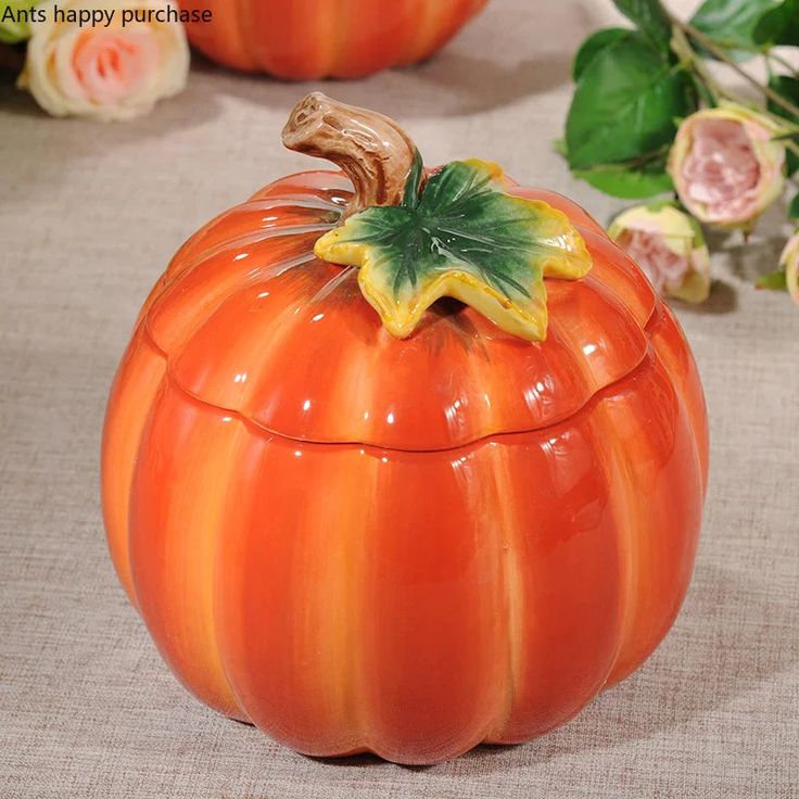 an orange pumpkin shaped container sitting on top of a table