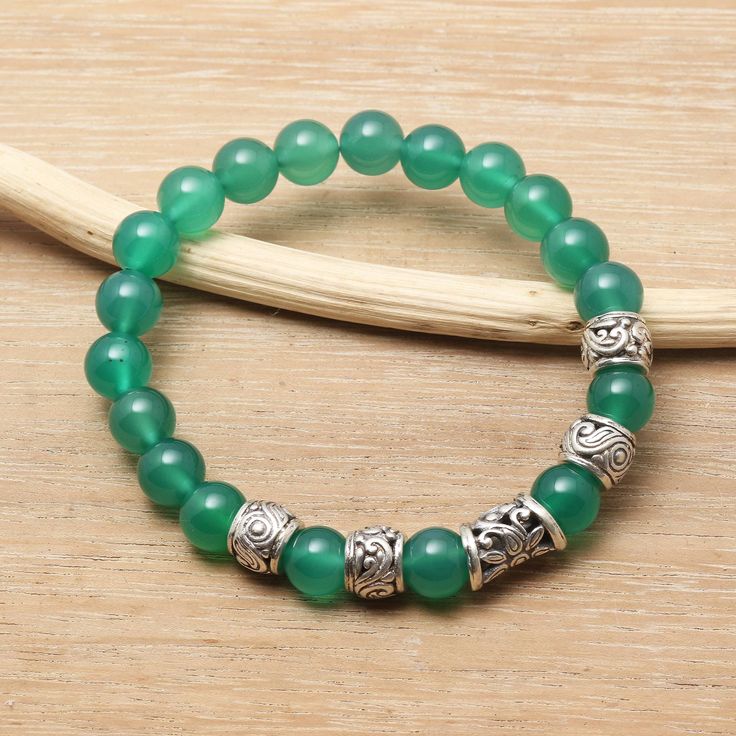 Ideal for an everyday look this charming stretch bracelet comes from talented artisan Asmara Putra. The attractive accessory features shiny round beads of green agate stones interspersed with sterling silver accents that are decorated with traditional Balinese openwork. Green Agate Beaded Bracelets With Gemstones, Casual Green Agate Bracelet, Hand-strung Silver Agate Beaded Bracelets, Green Agate Hand-strung Bracelets, Hand-strung Green Agate Beaded Bracelets, Sterling Silver Drop Earrings, Rose Quartz Beads, Agate Bracelet, Green Agate