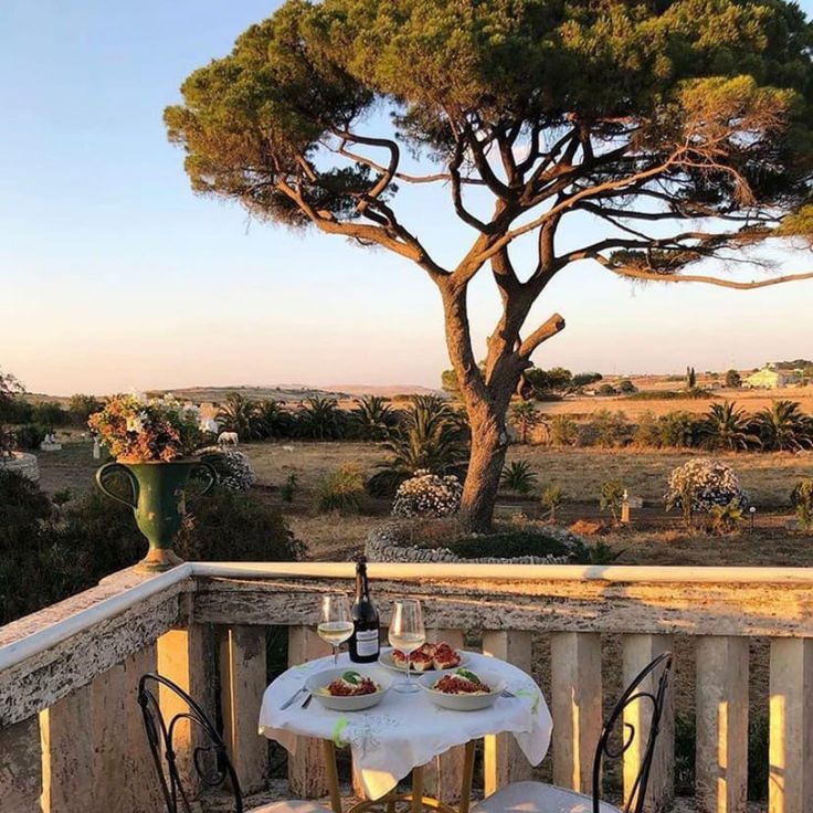 an outdoor table and chairs on a balcony