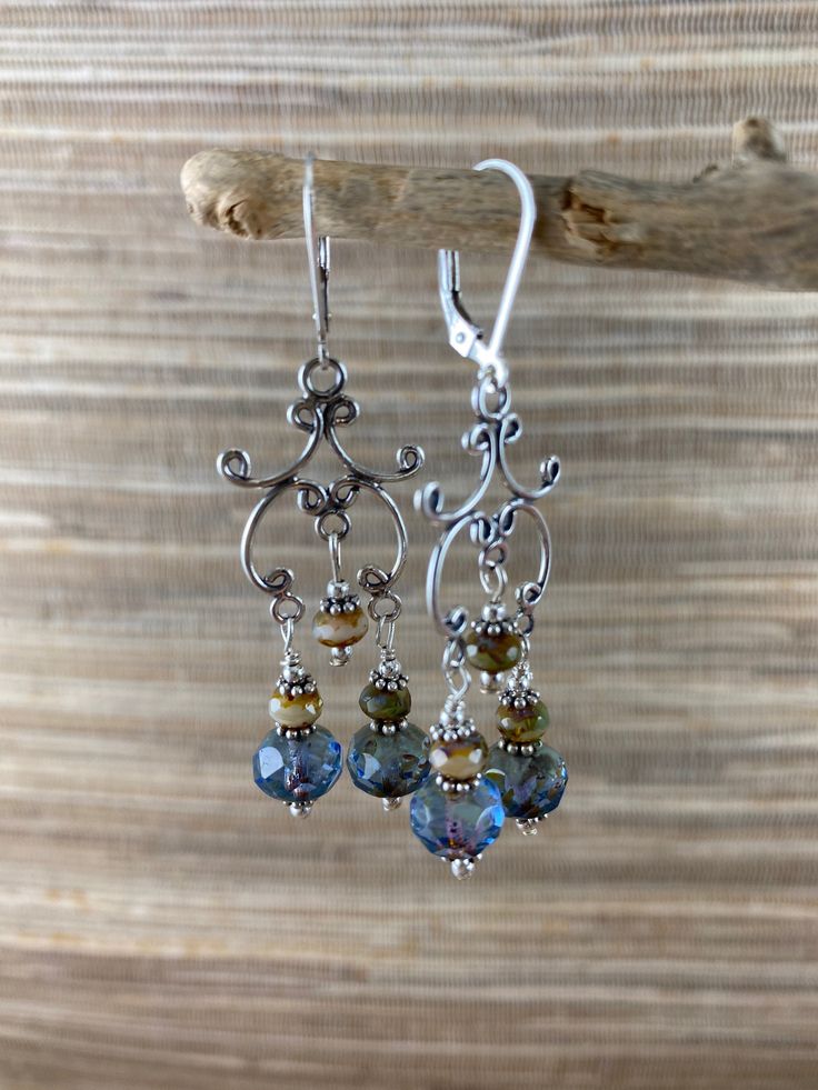 "Sterling silver and Czech glass chandelier earrings dangle 1-3/4\" from the bottom of sterling lever backs. Sky blue 8mm Czech glass rondelles are beautifully faceted and have a Picasso finish. The smaller 5mm rindelles are also faceted and are a mix of sky blue and an earthy colors. Lovely swing from the ear lobe." Silver Chandelier Earrings With Faceted Beads, Silver Chandelier Earrings With Round Beads And Ear Wire, Silver Chandelier Earrings With Round Beads, Elegant Nickel-free Chandelier Earrings With Round Beads, Elegant Hypoallergenic Czech Glass Crystal Earrings, Faceted Czech Glass Dangle Earrings, Silver Czech Glass Crystal Earrings With Ear Wire, Silver Crystal Earrings With Faceted Czech Glass Beads, Czech Glass Necklace