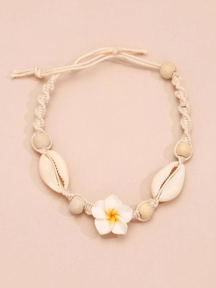 Anklet or bracelet is hand woven in a boho Macrame style of a natural colored cord, genuine seashells, wooden beads and clay white plumeria flower. Enhance the vibe of summer by adding this adorable white flower anklet to your collection. Bring the casual elegance to the spotlight by wearing it this summer. Pair it with sandals and matching summer jewelry.DIMENSIONS: about 11.0"LMATERIALS: clay, rope, beads, seashells White Plumeria, Macrame Flower, Shell Decor, Floral Bracelet, Boho Macrame, Summer Bracelets, Knot Bracelet, Bracelet Boho, Macrame Bracelets