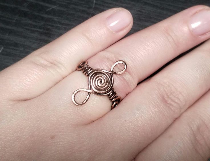 Pure copper ring in Viking swirl style. Fully handmade, hand polished and finished with jeweller's wax to prevent tarnish. UK size P. Copper Wire Wrapped Rings As Gift, Devil Horn Wire Ring, Adjustable Copper Rings, Handmade Adjustable Swirl Ring, Adjustable Copper Wire Wrapped Rings, Braided Copper Rings, Adjustable Viking Ring Jewelry, Handmade Copper Spiral Rings, Viking Ring