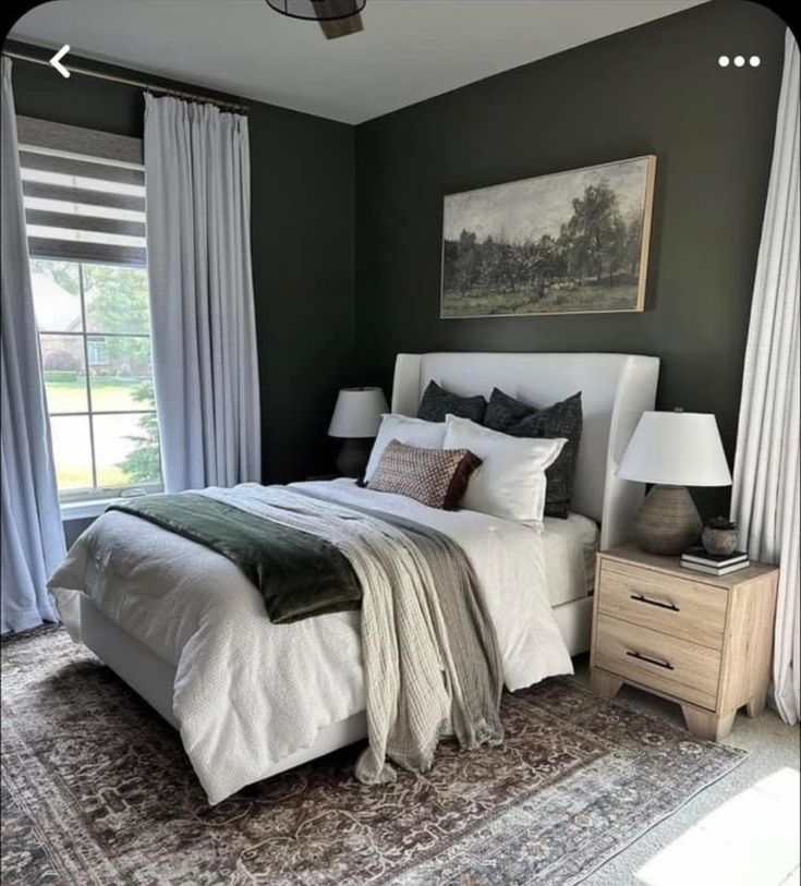 a large bed sitting in a bedroom next to a window