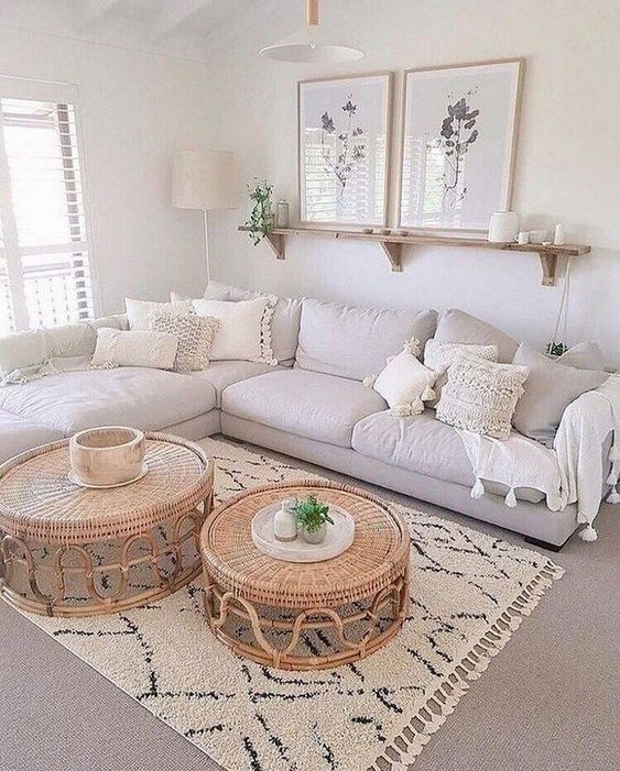 a living room filled with white furniture and pillows on top of a carpeted floor