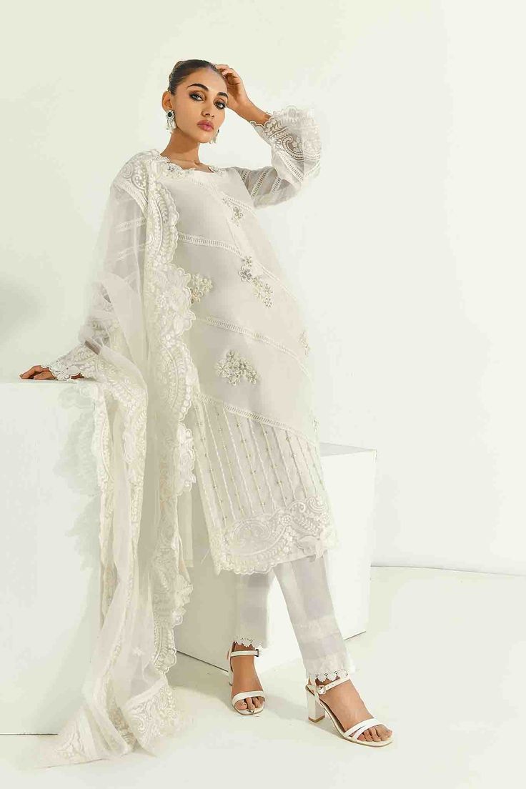 SKU: 1704 Price for Shirt lining and Pants Pure white silk net adorned with laces and hand embroidery of pearls, crystals, and resham and sequence work. The hemline is also adorned with organza and finished with lace details. The sleeves are made to perfection with lace details incorporated with self thread embroidery with cutwork. The gorgeous thread embroidered cutwork dupatta with 3D floral scattered all over can be added to this ensemble Festive Embellished Lace Sets, White Silk Sets With Sheer Dupatta, White Silk Set With Sheer Dupatta, White Long Sleeve Sets With Sheer Dupatta, Embellished Lace Sets For Wedding, Embellished Lace Wedding Sets, Wedding Lace Embellished Sets, White Silk Set With Pearl Embroidery, Elegant Embellished Cream Dupatta