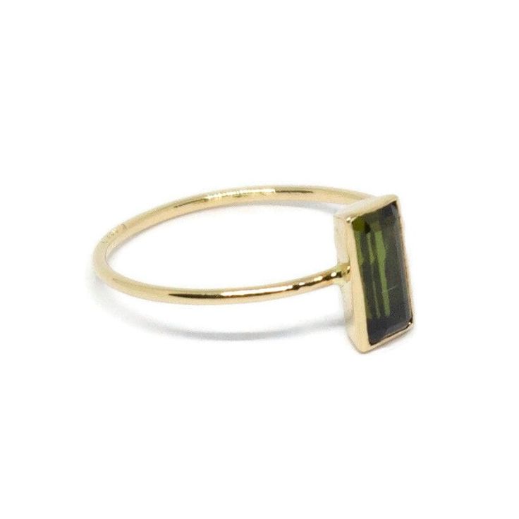 Our Peridot ring carries symbolic meanings. Peridot is known as the stone of abundance and prosperity, believed to attract positive energy and foster growth and harmony in one's life. Wear this ring as a personal talisman or gift it to someone special to convey your wishes for a prosperous journey. Heirloom Gold Tourmaline Ring, Yellow Gold Tourmaline Ring, Yellow Gold Tourmaline Ring With Polished Finish, Gold Tourmaline Ring For May Birthstone, Polished Tourmaline Ring As Gift, Polished Tourmaline Rings For Gift, Fine Jewelry Yellow Gold Tourmaline Rings, Faceted Tourmaline Ring Gift, Gold Tourmaline Rings With Polished Finish