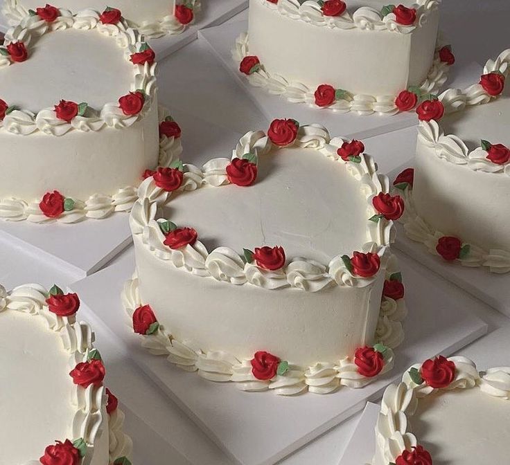 several heart shaped cakes with red roses on them are arranged in the shape of hearts