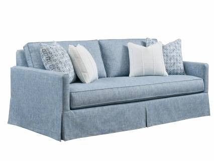 a blue couch with white pillows on it