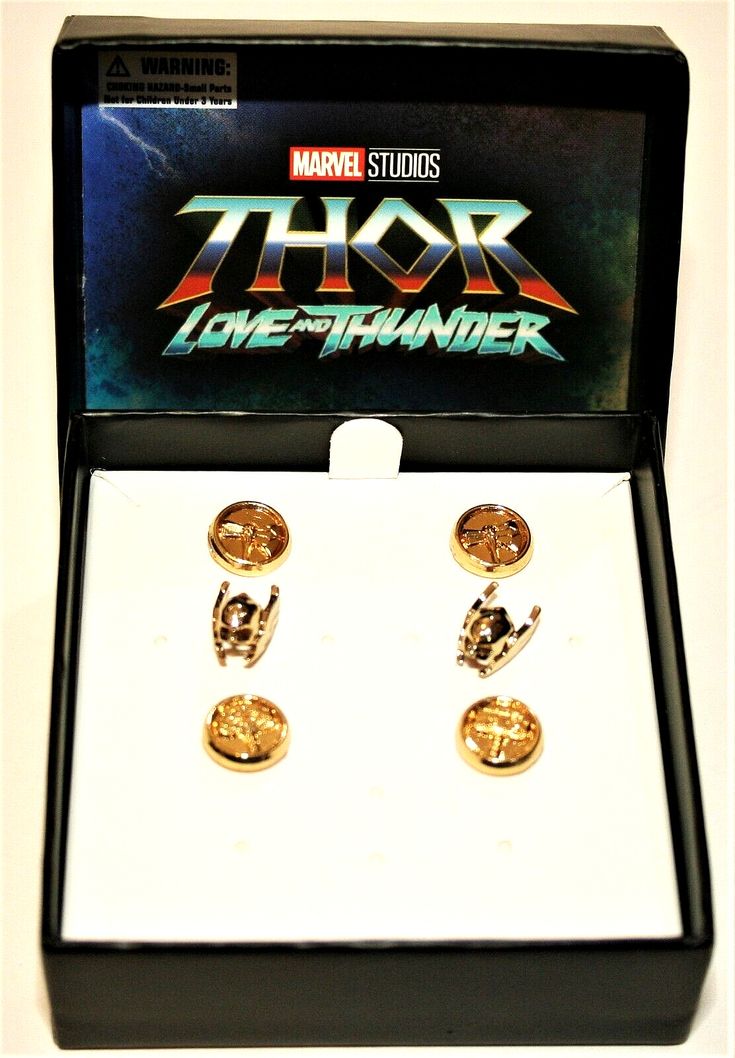 two cufflinks in a box with the title thor love and thunder written on them