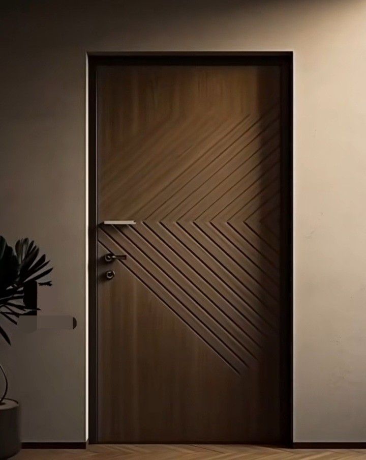 an empty room with a door and potted plant on the floor next to it