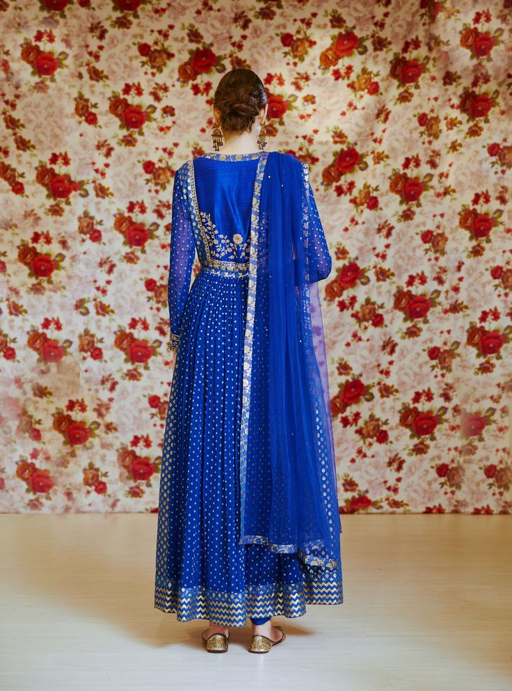 Editor's Note This set features a royal blue embroidered long kurta with dupatta and trouser. Color: Royal Blue Fabric: Silk Chnderi Brocade And Georgette Embroidery Details: Zardozi Care: Dry Clean Only Customize Your Outfit Can't find the size you're looking for? No stress. Just select the size "Custom" while adding the item to your cart. We will follow up with you for your body measurements. To request a color or design customizations, please contact our customer care by using our "Ask us a q Transitional Season Blue Anarkali Lehenga, Blue Festive Anarkali Set With Traditional Drape, Blue Anarkali Set For Festive Occasions, Festive Blue Anarkali Set With Traditional Drape, Blue Kurta For Reception And Navratri, Blue Kurta For Reception During Navratri, Blue Anarkali Set With Zari Work For Transitional Season, Transitional Blue Anarkali Set With Zari Work, Festive Blue Chanderi Anarkali Set