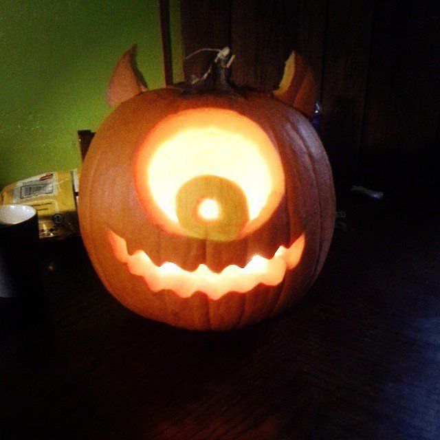 a carved pumpkin sitting on top of a wooden table