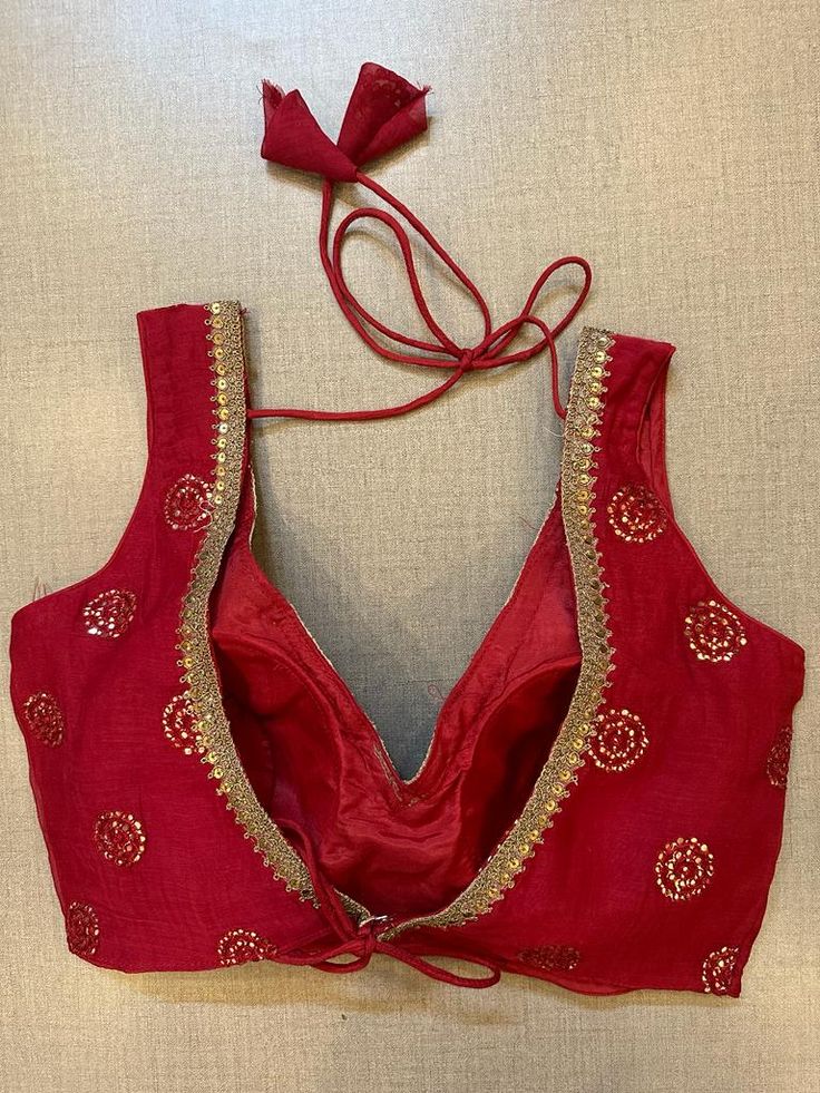 Alluring red embroidered sleeveless designer saree blouse. Buy designer blouse in USA from Pure Elegance. Disclaimer: The actual product may vary slightly from the image. These are custom orders, hence expect slight variation in color, placement of the motif or buta. ESTIMATED DELIVERYBecause this is a custom order, it would take about 4 weeks from the date of purchase. RETURN POLICY: This product is a custom order and cannot be returned or exchanged. Sleeveless Chanderi Traditional Wear For Party, Festive Sleeveless Traditional Wear With Cutdana, Traditional Chanderi Lehenga, Traditional Sleeveless Chanderi Lehenga, Designer Wear Sleeveless Art Silk Saree, Sleeveless Art Silk Traditional Wear With Cutdana, Sleeveless Chanderi Traditional Wear For Navratri, Sleeveless Cutdana Traditional Wear For Diwali, Sleeveless Red Lehenga For Diwali