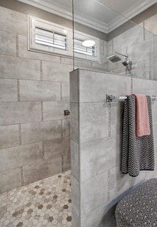 a walk in shower sitting next to a toilet