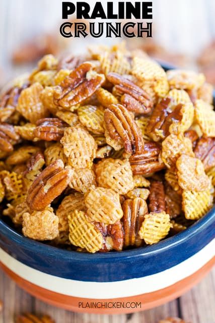 a blue bowl filled with pecans on top of a wooden table