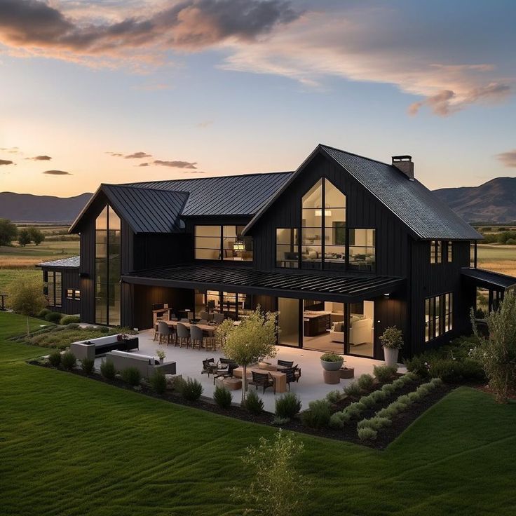 this is an aerial view of a modern house at dusk with the sun setting in the background