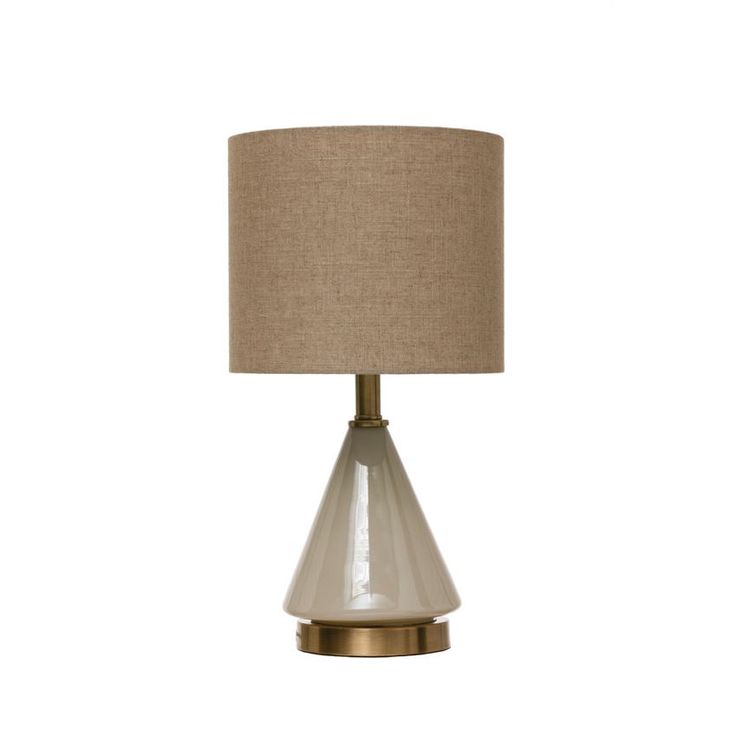 a table lamp with a beige shade on it