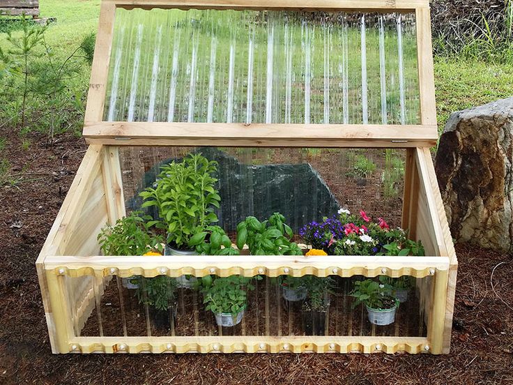 a wooden box filled with plants and flowers