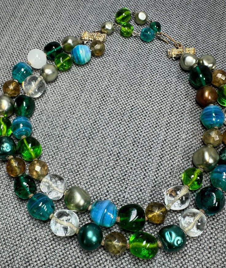 Vintage Double Strand Multi Colored Sea Green, Turquoise, Opalescent, Faceted & Mixed Bead Necklace, Internal Bubbles, Hook Clasp, c. 1950s . Gorgeous mix of sea green bubble glass beads, clear, faceted, turquoise opalescent swirl, and more.  Double strand with hook clasp.  Measures 12" + 3" extension for a total of 15".  Second strand has ~3" drop.  In good vintage condition showing no visible damage.  Please see additional listings for more vintage jewelry at great prices! Luxury Vintage Beaded Necklaces With Colorful Beads, Luxury Vintage Double Strand Jewelry, Vintage Green Double Strand Necklaces, Vintage Green Double Strand Necklace, Vintage Multi-strand Turquoise Jewelry, Vintage Turquoise Single Strand Necklace, Vintage Green Beads For Jewelry Making, Vintage Green Beaded Necklaces With Round Beads, Vintage Green Beaded Necklace With Round Beads