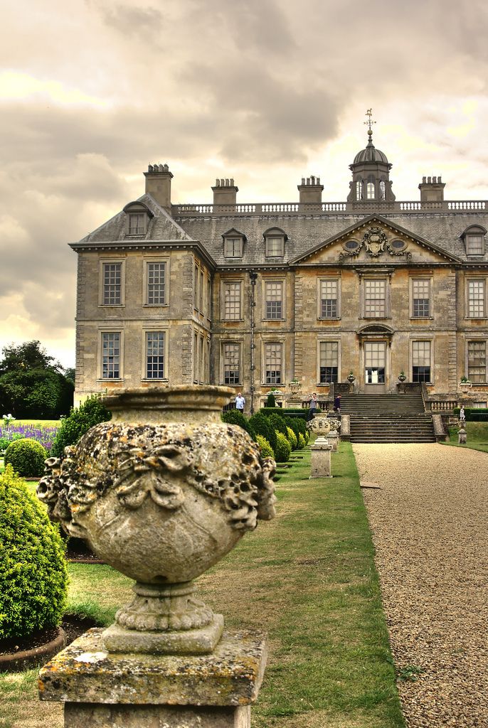 a large stone building sitting on top of a lush green field