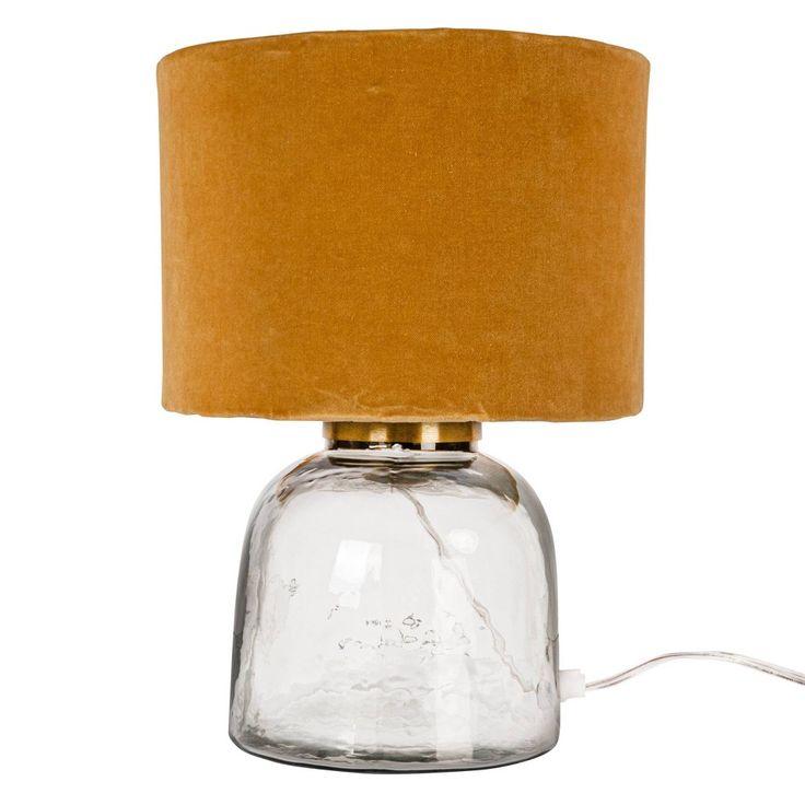 a glass lamp with a brown shade on it's side and a cord plugged into the base