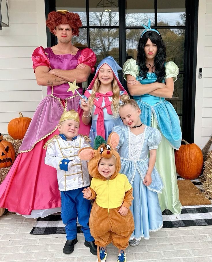 a group of people dressed up as disney and the princesses posing for a photo