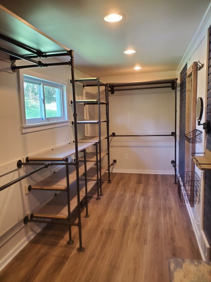 an empty room with shelves and ladders in it