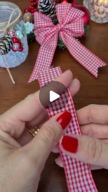 someone is making a ribbon with red and white checkered fabric