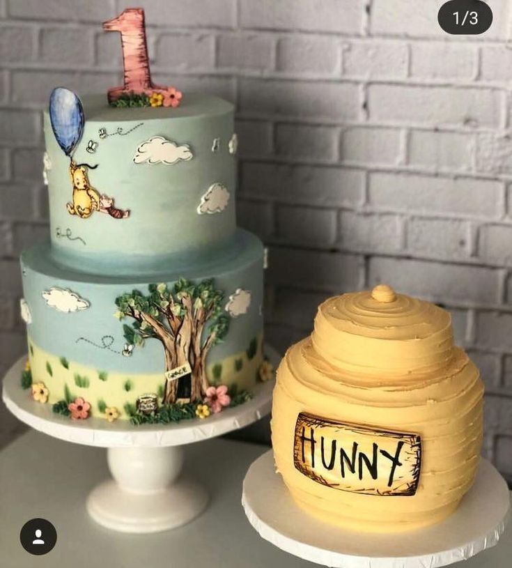 two cakes with winnie the pooh designs on them, one is blue and the other is yellow