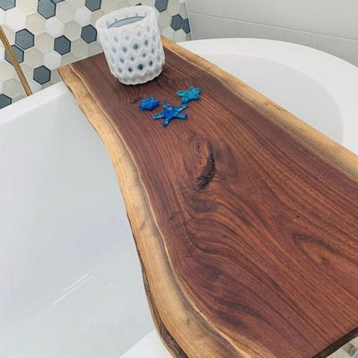 a wooden tray sitting on top of a bath tub